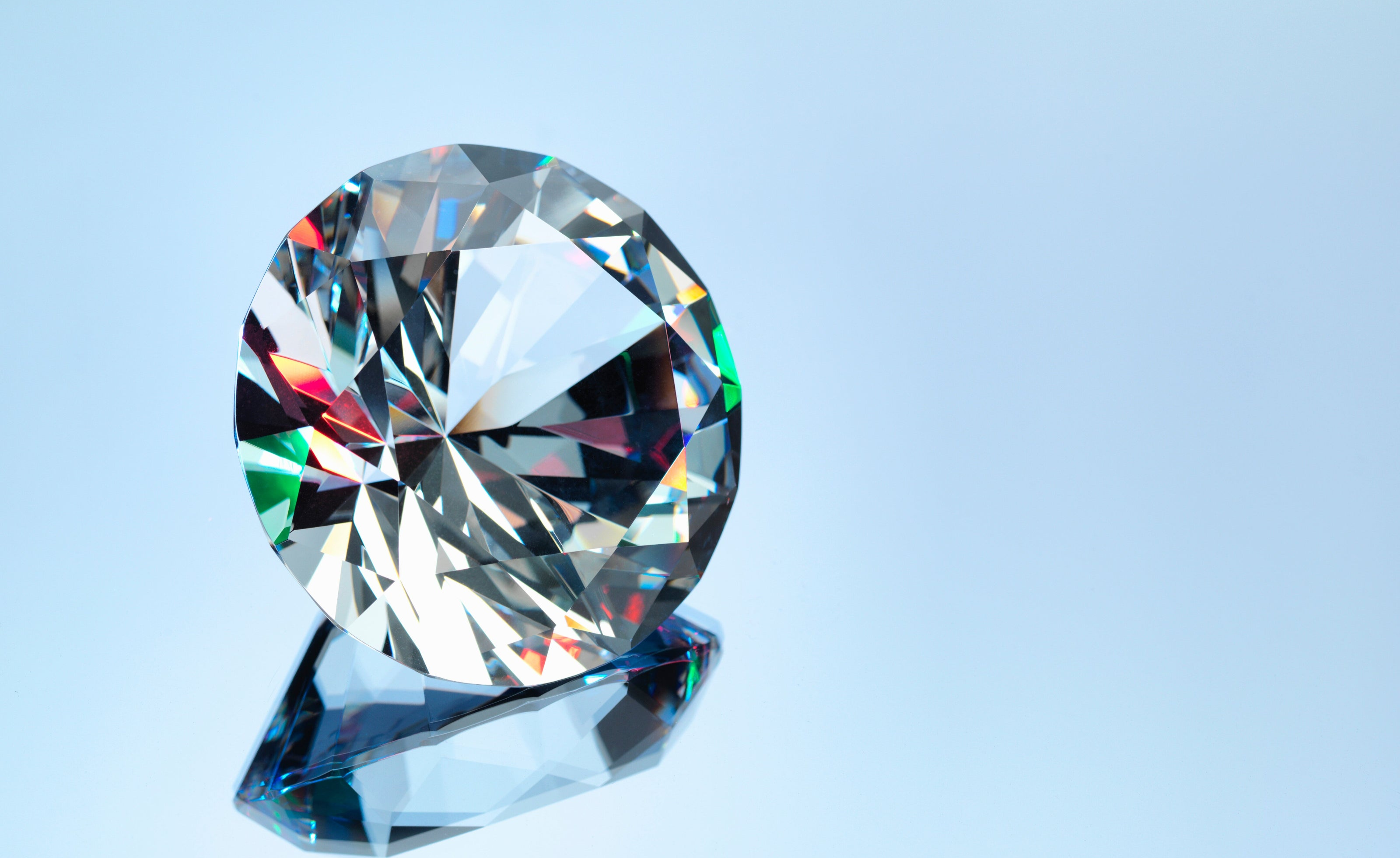 Diamond on a stand against a light blue background