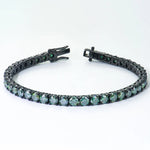 Black gold bracelet with green UltraLux moissanite on a white background