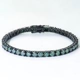 Black metal bracelet with green gemstones on a white background