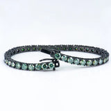 Green gemstone bracelet with black metal clasp on a white background