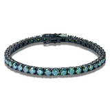 Black metal bracelet with green gemstones on a white background